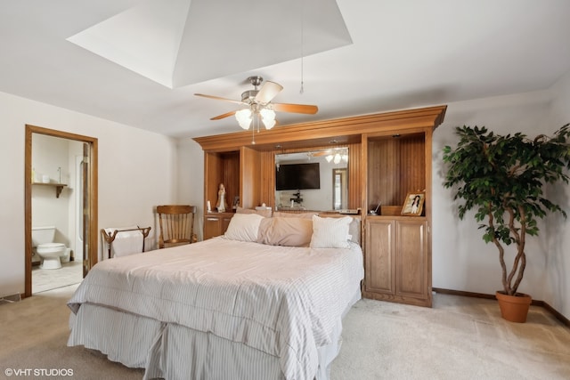 carpeted bedroom featuring ceiling fan and ensuite bathroom