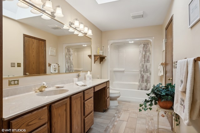 full bathroom with a skylight, toilet, shower / bath combo with shower curtain, and vanity