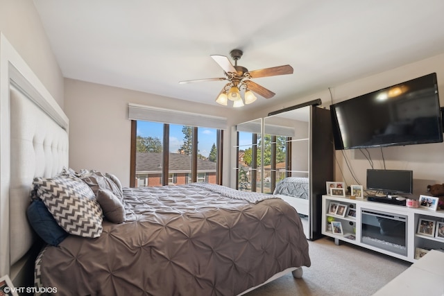 bedroom with access to exterior, ceiling fan, and carpet floors