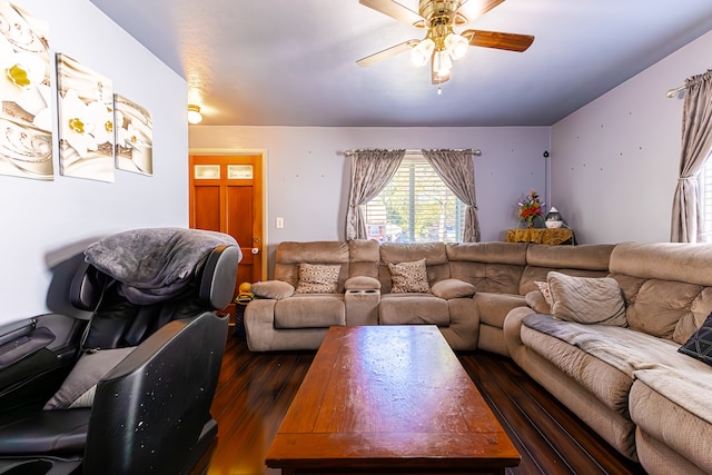 living room featuring ceiling fan and dark wood-type flooring