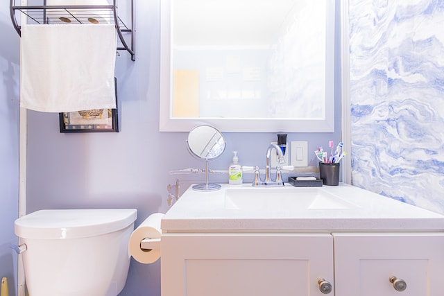 bathroom featuring vanity and toilet