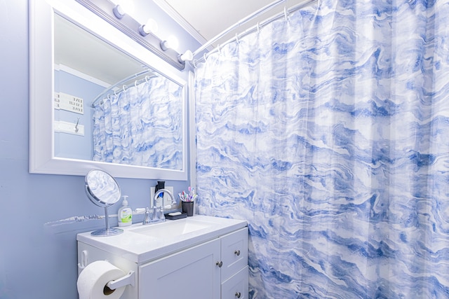 bathroom featuring vanity and ornamental molding