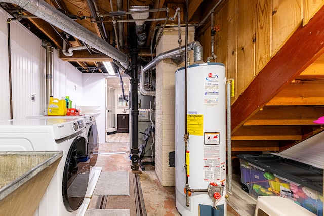 basement featuring water heater and washing machine and dryer