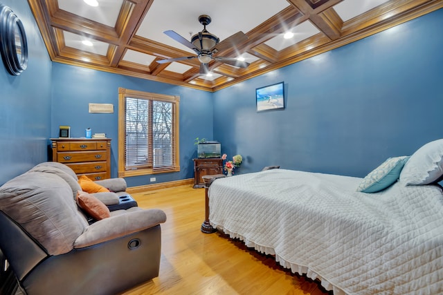 bedroom featuring light wood-type flooring, coffered ceiling, and ceiling fan