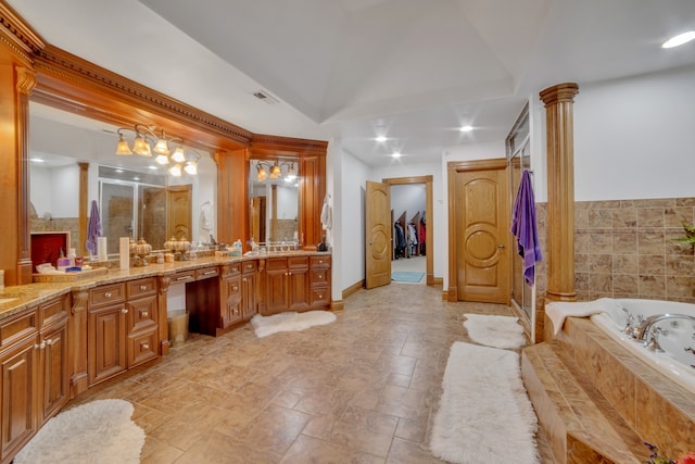 bathroom featuring shower with separate bathtub, decorative columns, and vanity