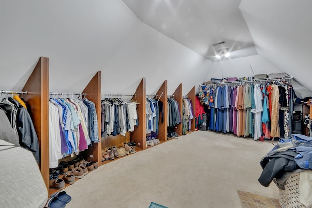 walk in closet featuring lofted ceiling and carpet flooring