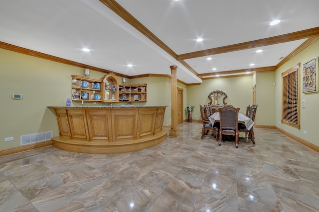 bar featuring ornamental molding, light stone counters, and ornate columns