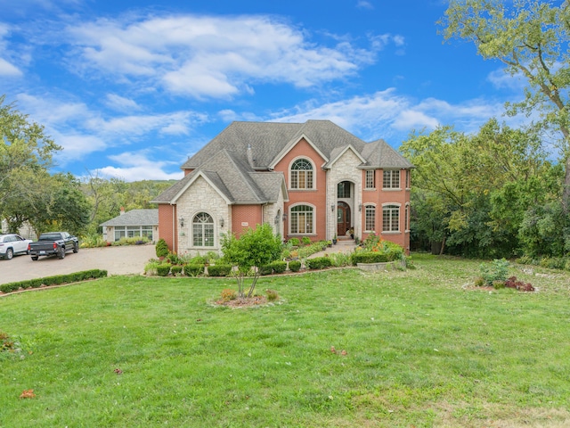 french country inspired facade with a front yard