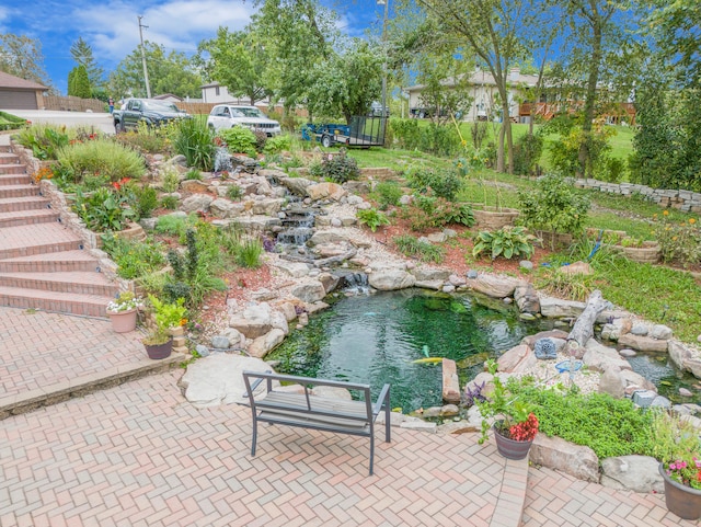 view of patio / terrace featuring a small pond