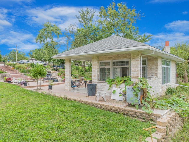 back of property with a patio and a yard