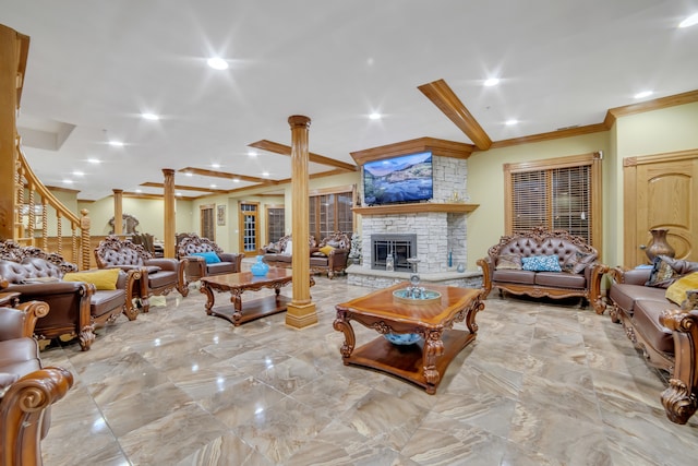 living room with crown molding, a stone fireplace, beam ceiling, and ornate columns