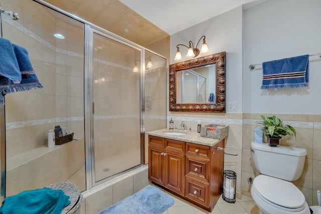 bathroom featuring walk in shower, vanity, tile walls, and toilet