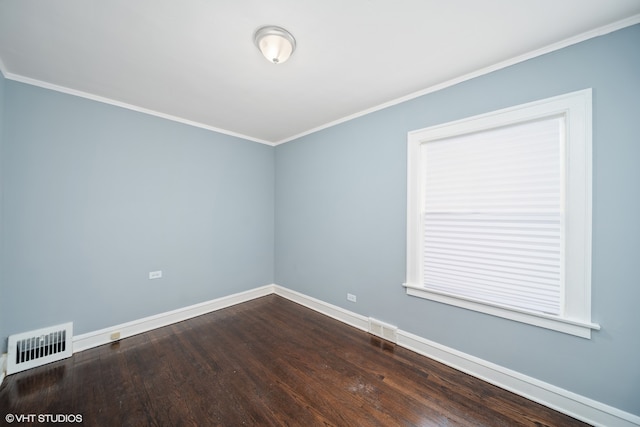 empty room with crown molding and hardwood / wood-style floors