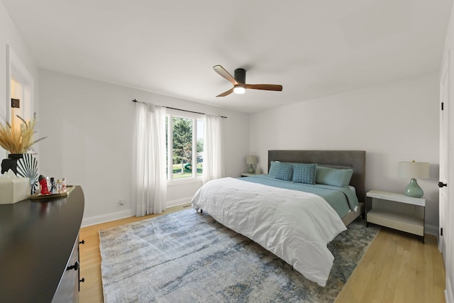 bedroom with ceiling fan and wood-type flooring