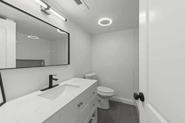 bathroom with vanity, toilet, and tile patterned floors