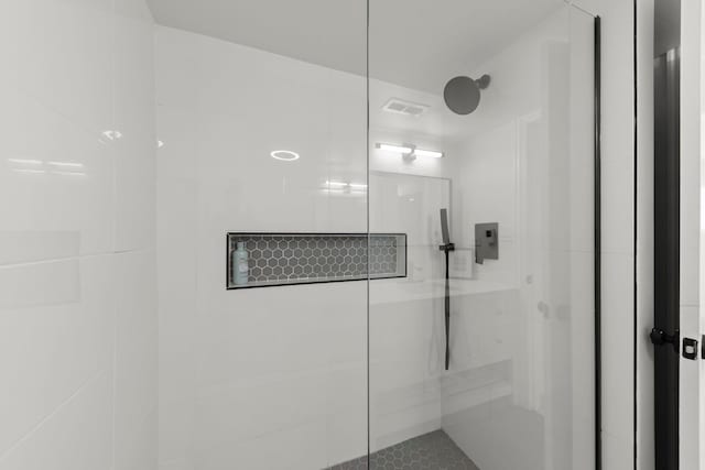 bathroom featuring a shower with shower door