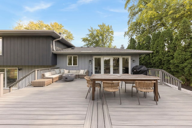 wooden deck with outdoor lounge area and a grill