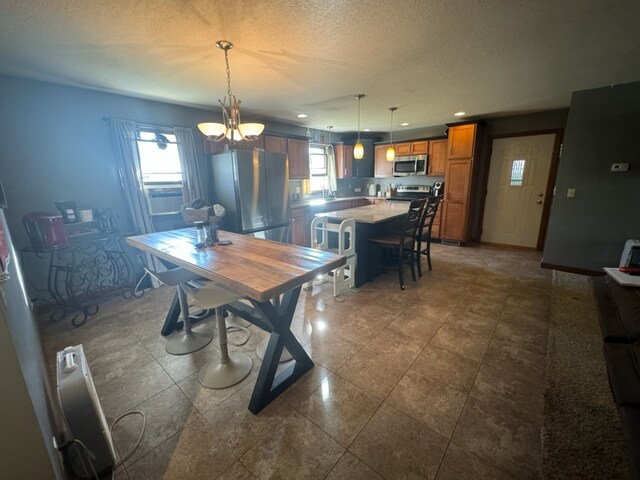 dining room with a textured ceiling, a healthy amount of sunlight, an inviting chandelier, and cooling unit