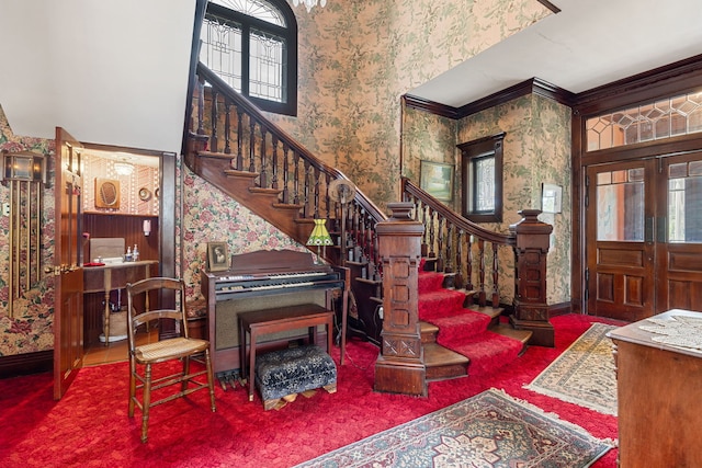 carpeted entrance foyer with ornamental molding