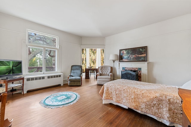 bedroom featuring wood-type flooring and radiator