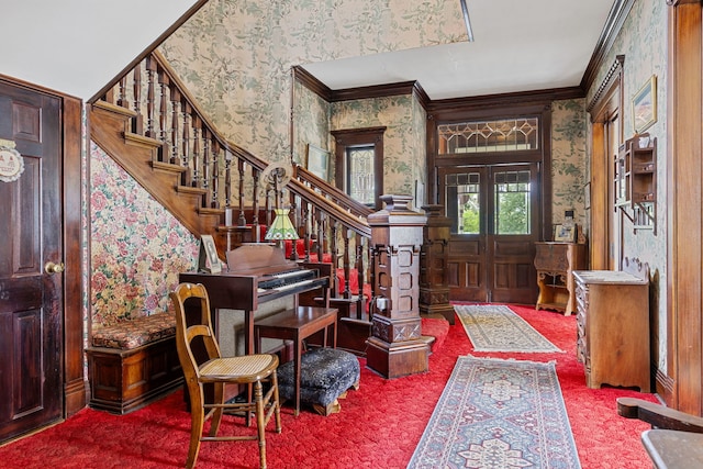 foyer with french doors, carpet flooring, and crown molding