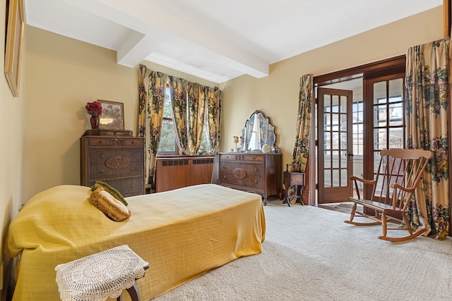 carpeted bedroom featuring radiator and beamed ceiling