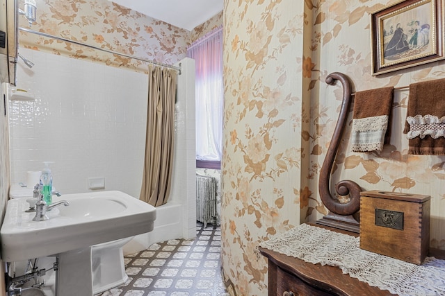 bathroom with radiator and shower / bath combo with shower curtain