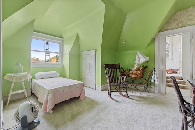 carpeted bedroom with lofted ceiling