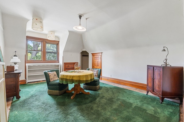 dining area with vaulted ceiling and carpet flooring