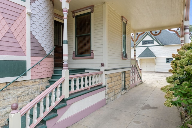 view of home's exterior with a garage and covered porch