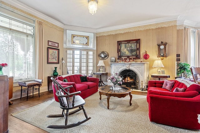 interior space with ornamental molding, a wealth of natural light, and wood-type flooring