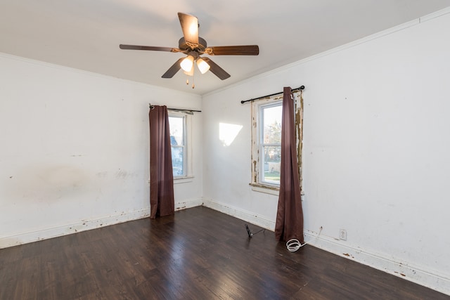 unfurnished room featuring dark hardwood / wood-style floors, crown molding, and ceiling fan