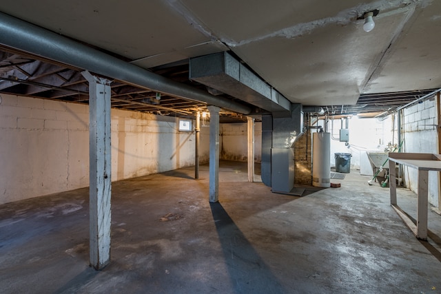 basement with gas water heater, heating unit, and washer / clothes dryer