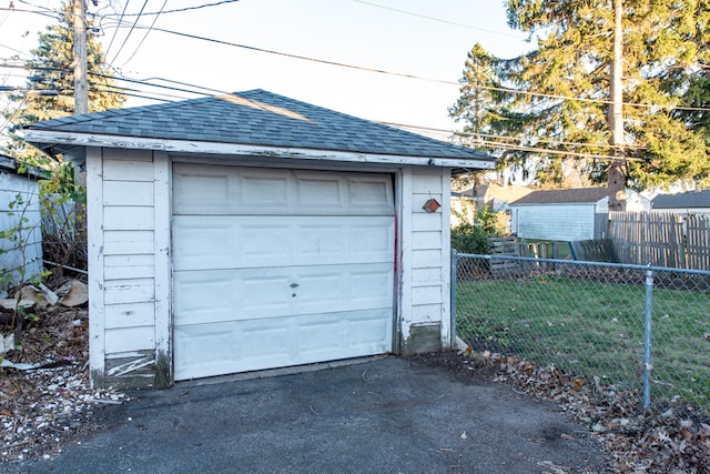 garage featuring a lawn