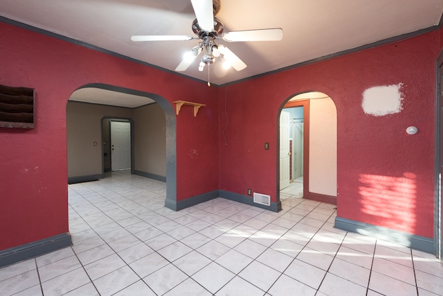 unfurnished room with ornamental molding, ceiling fan, and light tile patterned floors