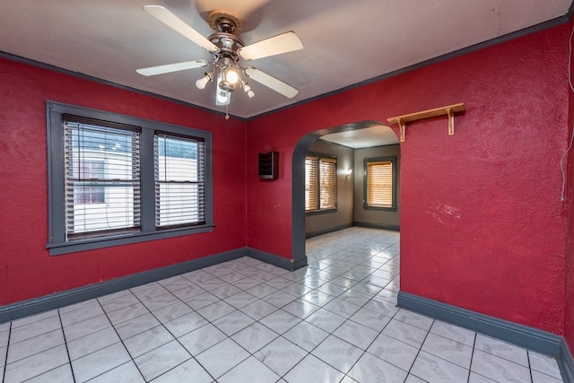 tiled spare room featuring ceiling fan