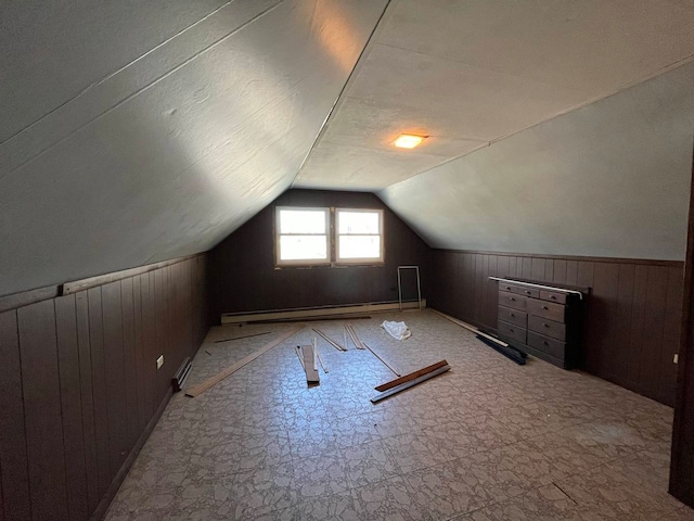 bonus room featuring a baseboard heating unit, wooden walls, lofted ceiling, and a textured ceiling