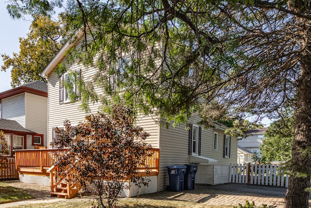 view of side of home with a wooden deck