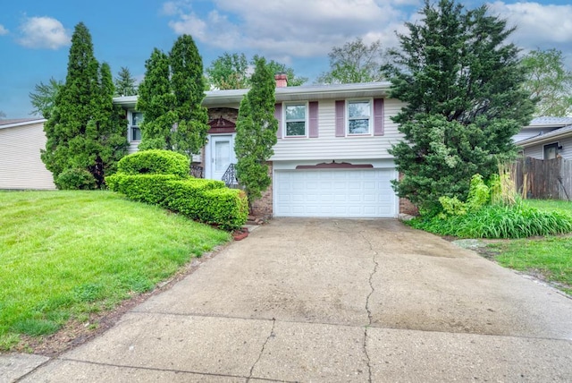 view of front of house featuring a garage and a front lawn