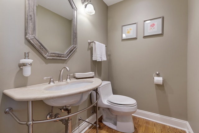 bathroom featuring hardwood / wood-style floors and toilet