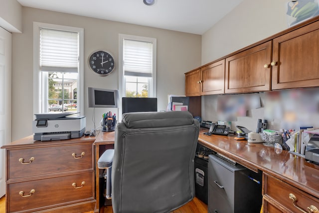 home office with light hardwood / wood-style flooring and plenty of natural light