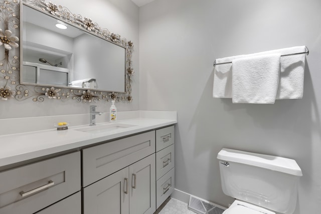 bathroom featuring vanity, toilet, and tile patterned floors