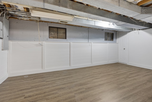 basement with hardwood / wood-style floors