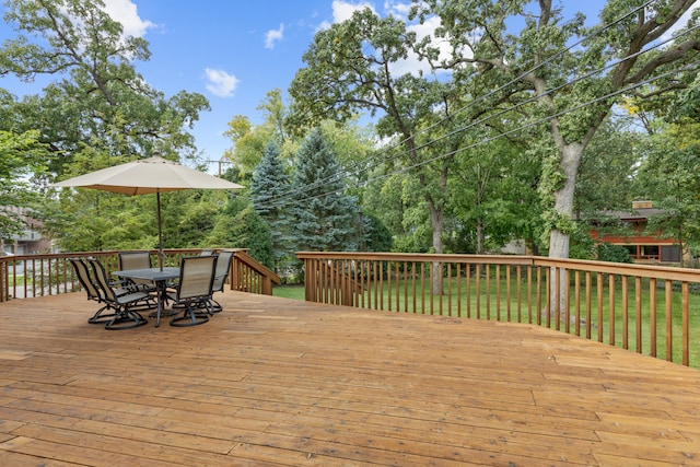 wooden terrace featuring a lawn