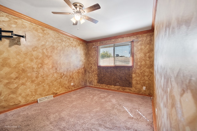 carpeted empty room featuring ceiling fan and ornamental molding