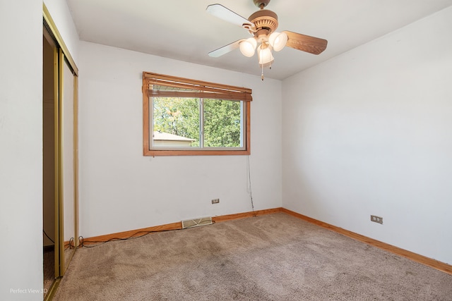 unfurnished bedroom featuring carpet, ceiling fan, and a closet