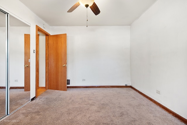 empty room featuring ceiling fan and carpet floors