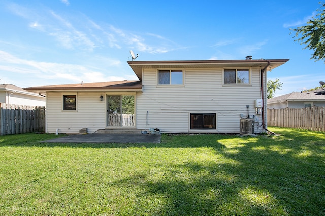 back of property with a patio area and a yard