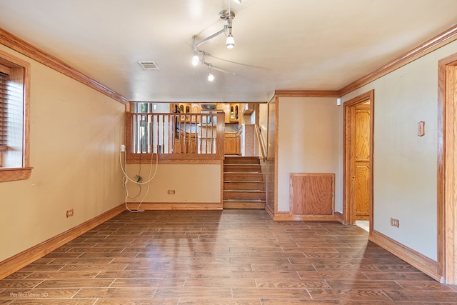 unfurnished room featuring rail lighting, dark hardwood / wood-style floors, and crown molding