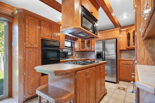 kitchen featuring backsplash, stainless steel appliances, beamed ceiling, tile counters, and light tile patterned flooring